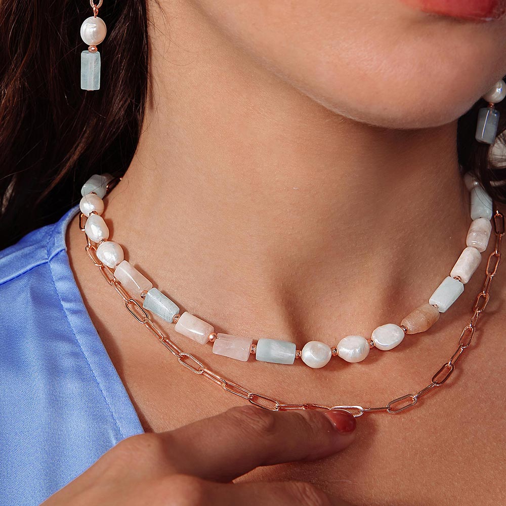 Aimee freshwater pearl and stone multi-way necklace two layered close up with hand on chain.
