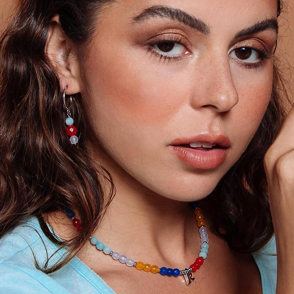 Bianka beaded multicolour stone initial necklace with earrings on right ear.