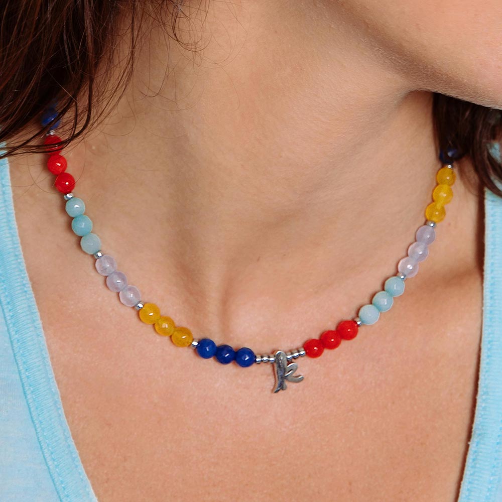 Bianka beaded multicolour stone initial necklace with letter k close up of neck.