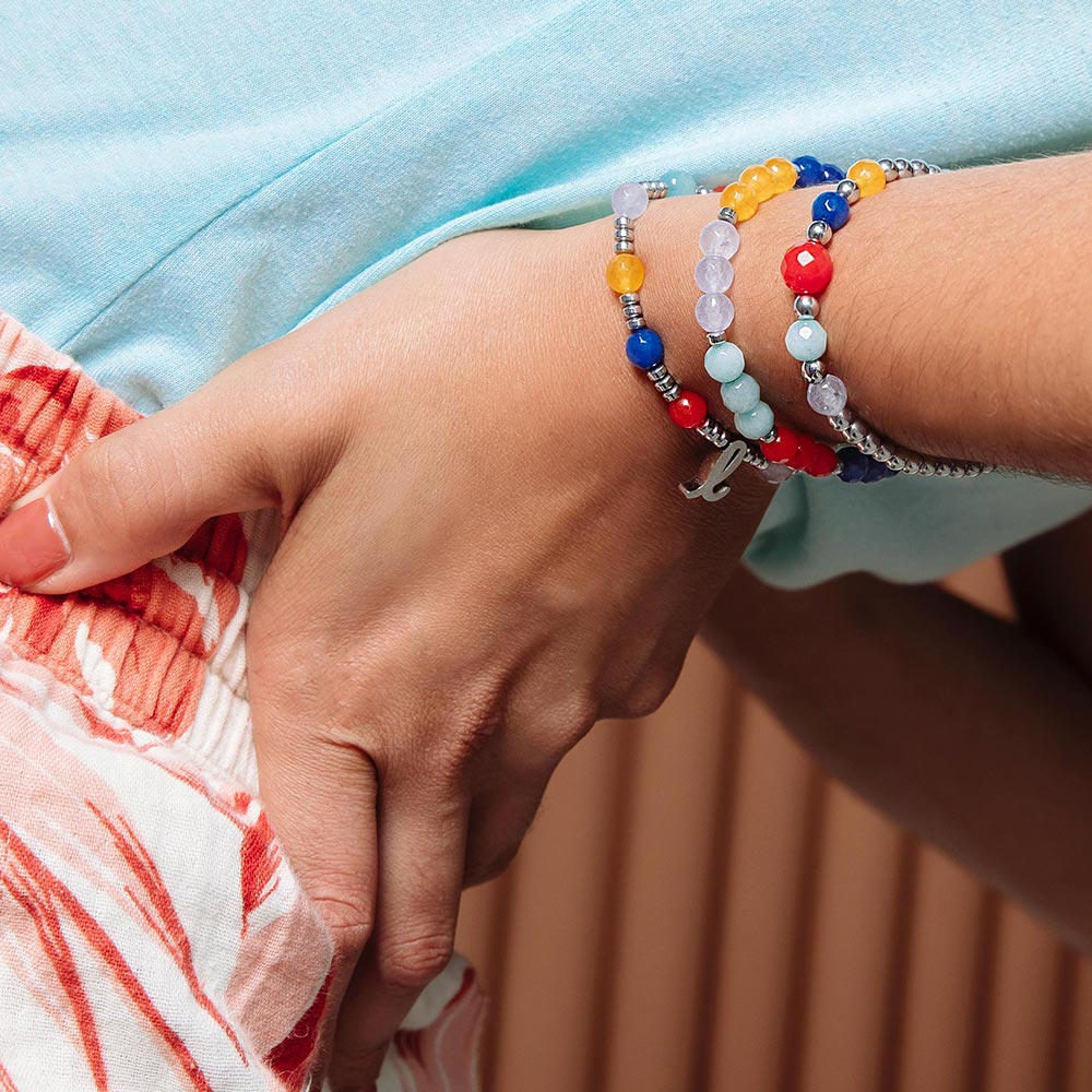 Bianka beaded stone bracelet set with initials on left hand behind back