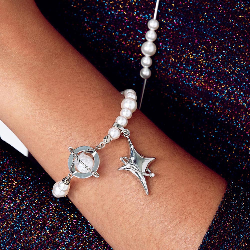 Duchess celestial pearl charm bracelet left arm close up.