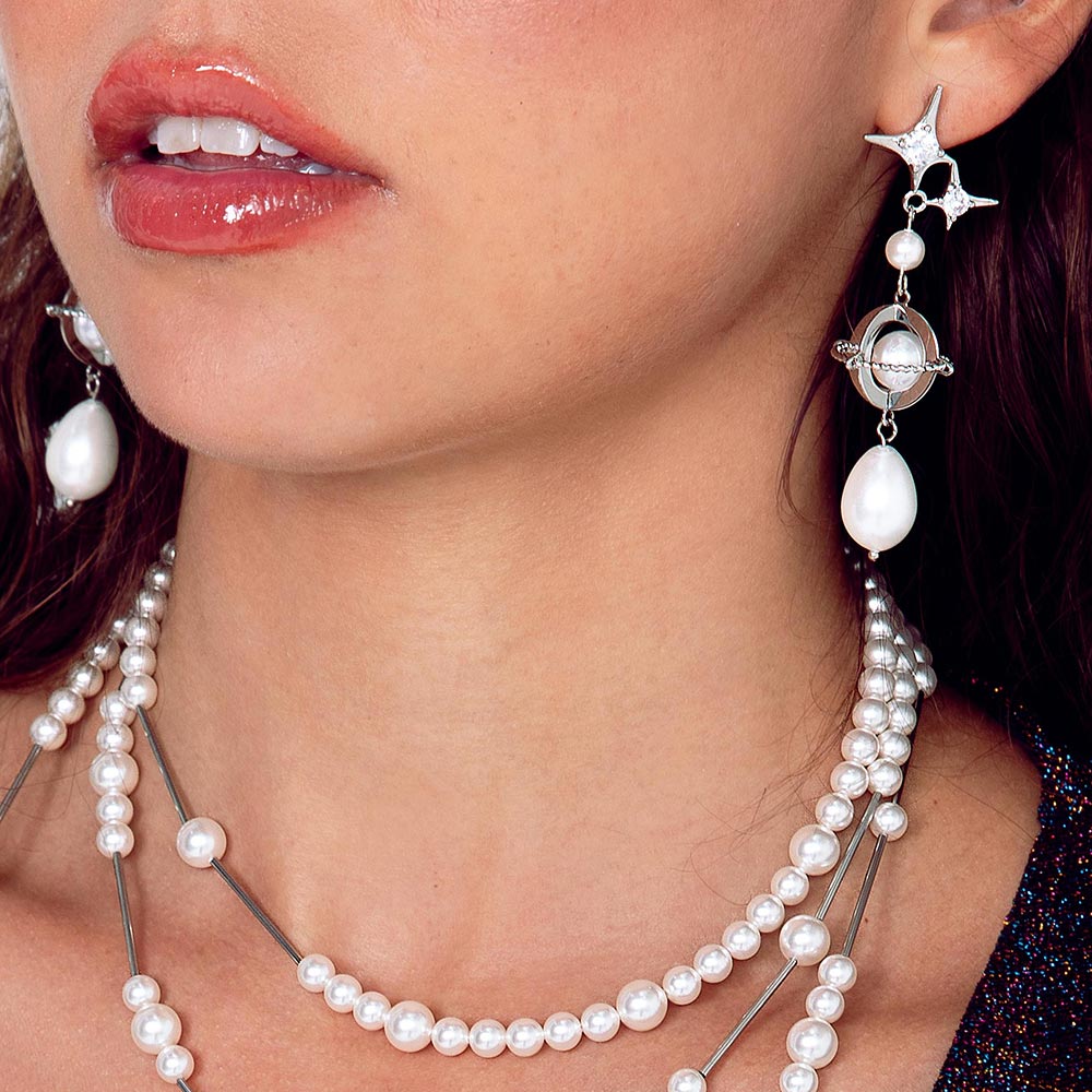 Duchess celestial silver and pearl drop earrings close up on left ear and top strand of Duchess pearl necklace.