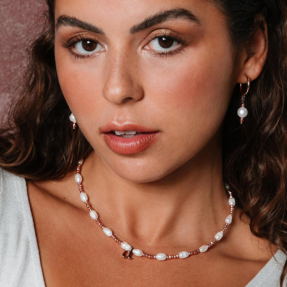 Tarni personalised rose gold and pearl inital necklace with d initial and rose gold hoop earrings left side