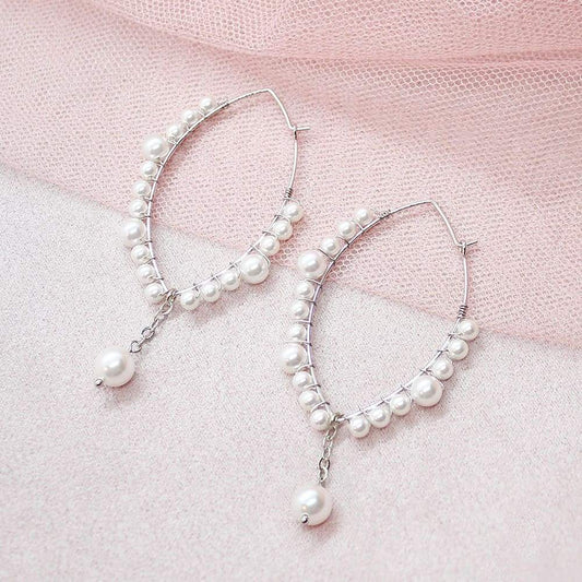 Off-white Ora Pearl Hoop Earrings on pink