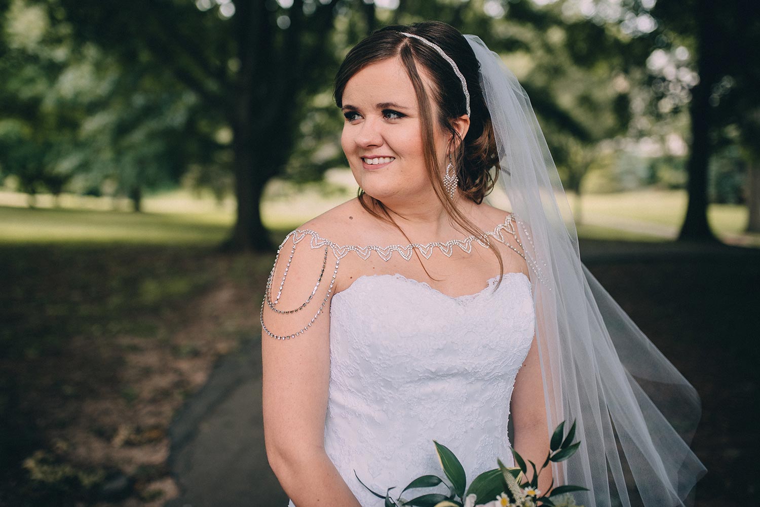 Ashley in white wedding dress with custom crystal shoulder necklace