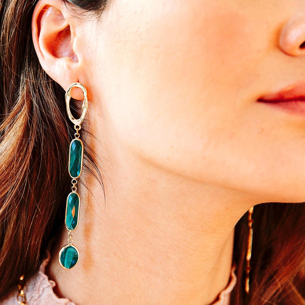 Azaria long teal crystal gold earrings close up right ear