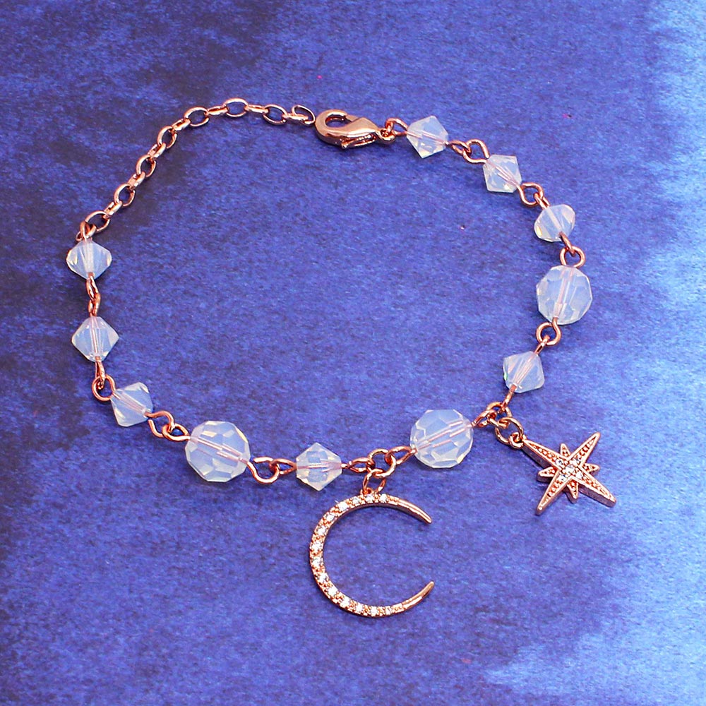 Callista moon and star bracelet on blue gradient background