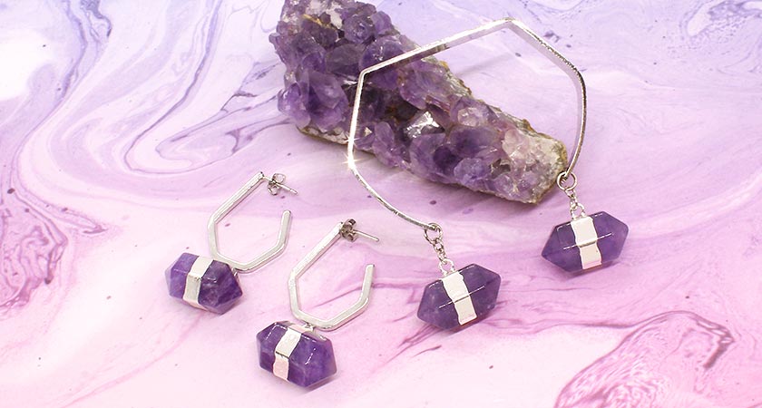 Chakra amethyst hexagon stone earrings and cuff bracelet on purple swirl background