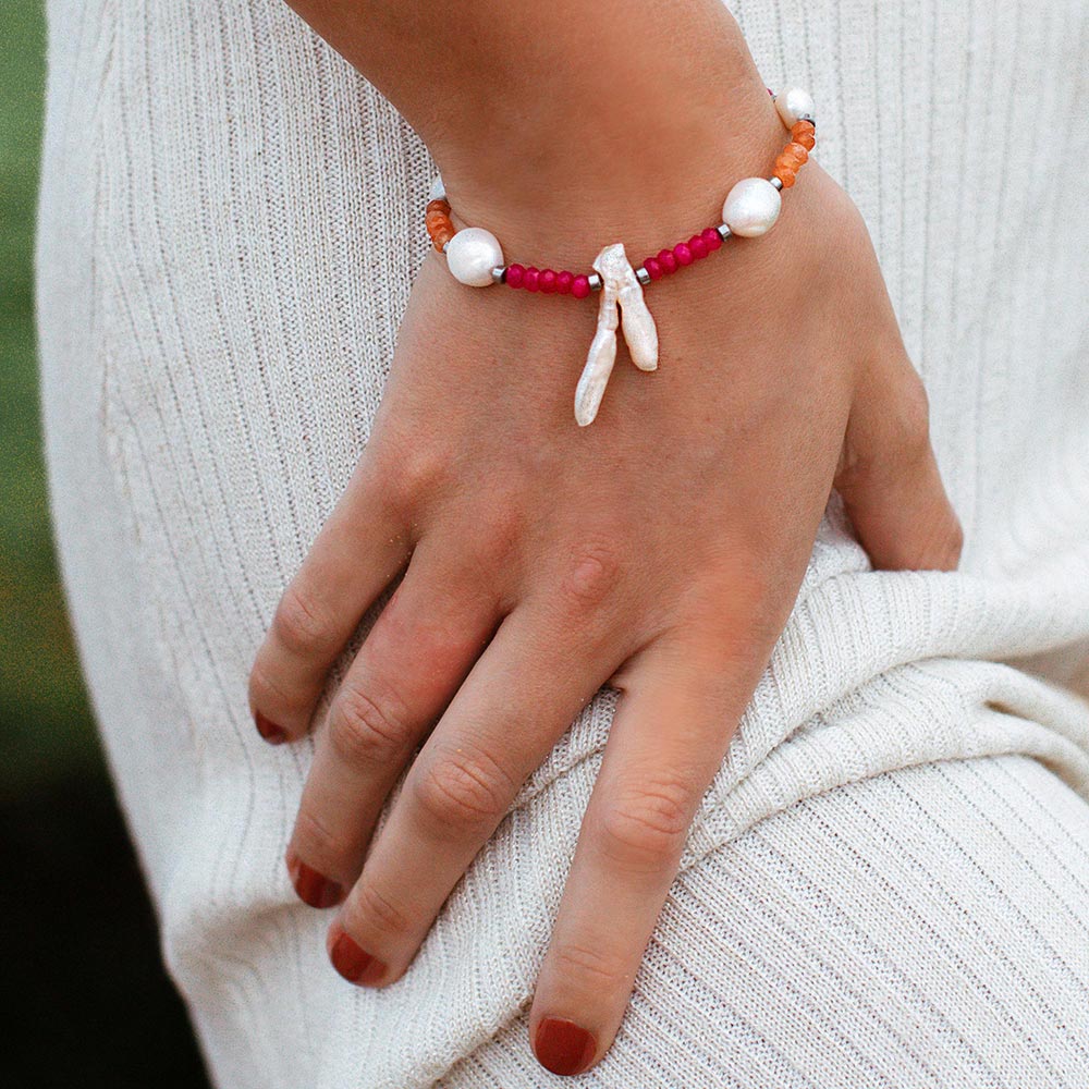 Halley multi coloured semi-precious stone and pearl bracelet orange and fuchsia with silver close up right hand on hip