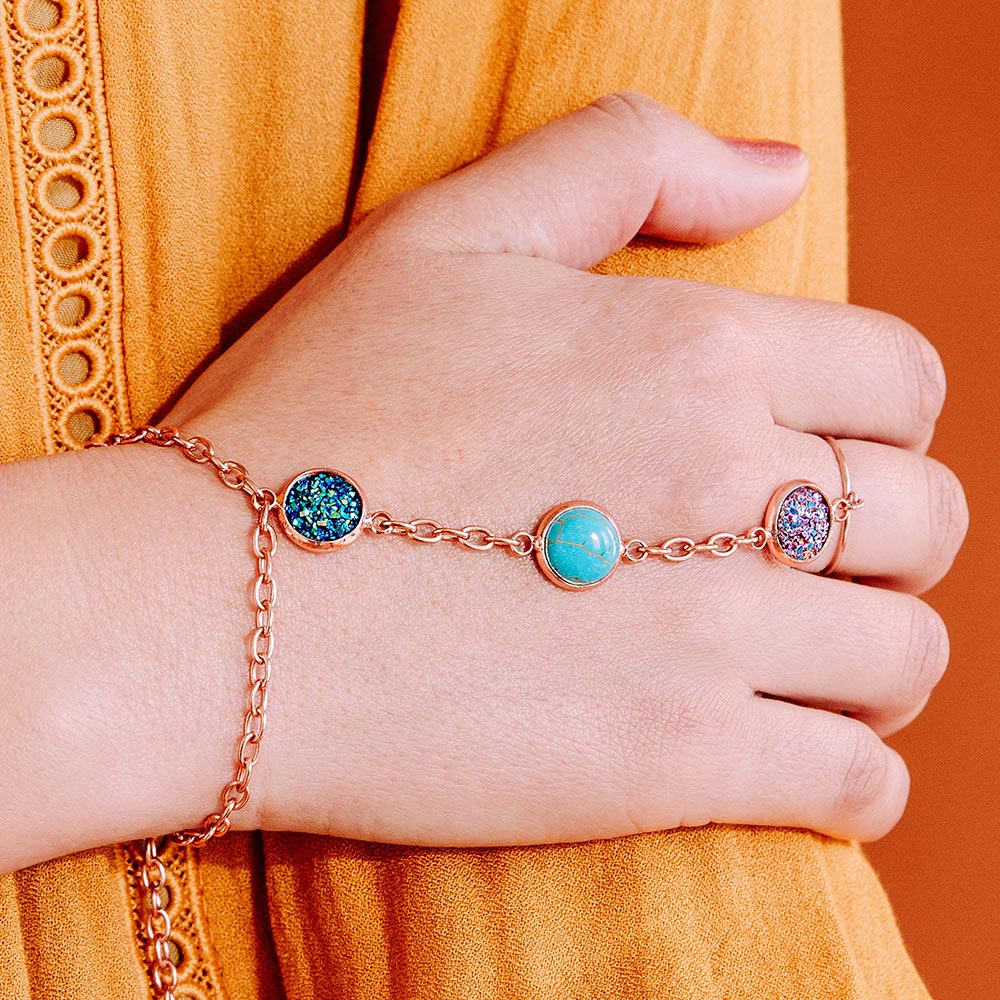 Jorja druzy ring bracelet chain rose gold multi-colour stones close up right hand with mustard top