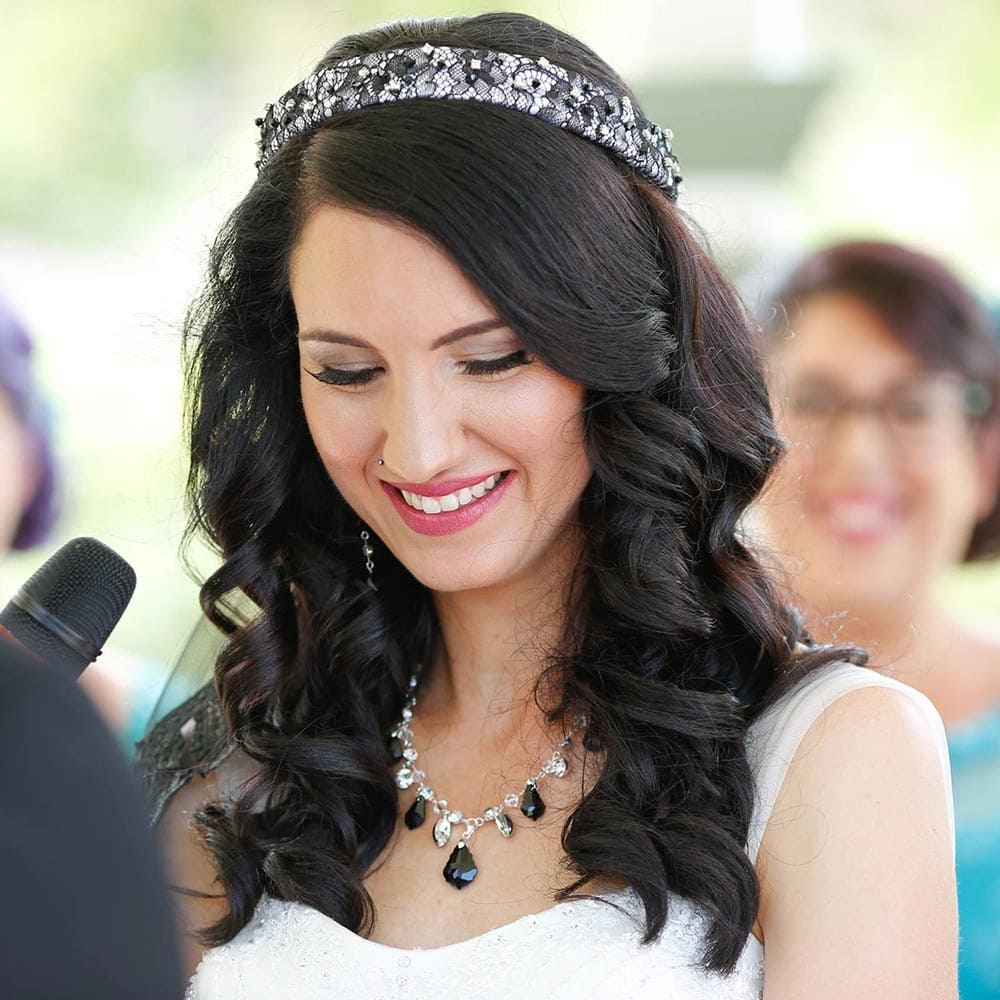 Kate wears a custom gothic headpiece and necklace with white wedding dress for a gothic themed wedding