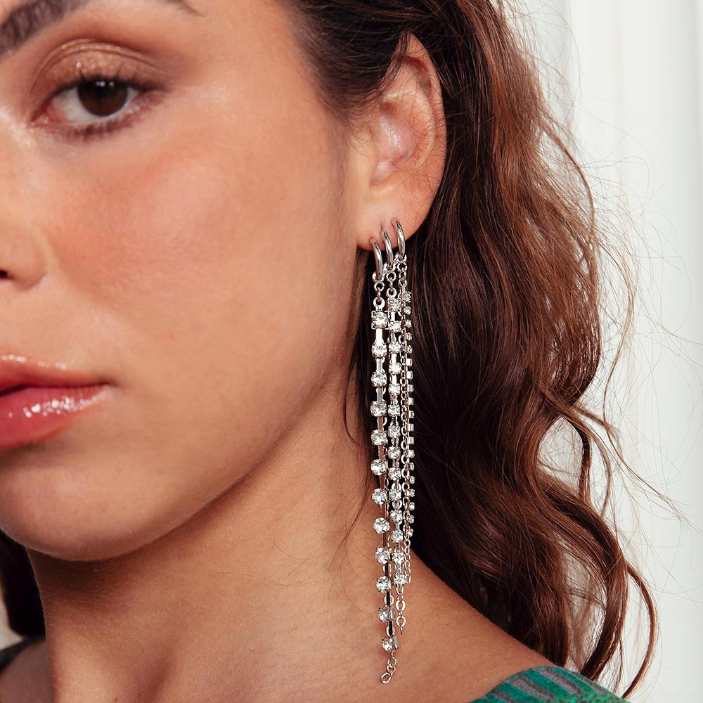 Keisha long rhinestone chain tassel earrings on left ear close up.