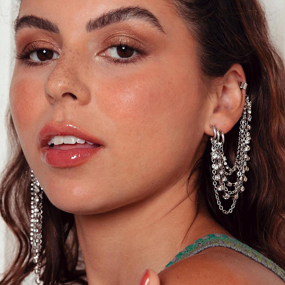 Keisha rhinestone and chain ear cuff earring on left ear.