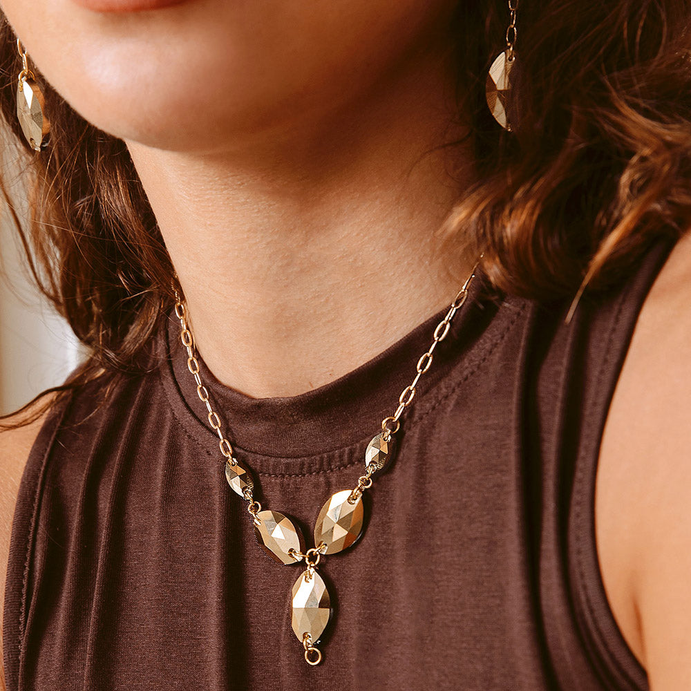 Kyra gold crystal necklace part only close up worn with brown dress