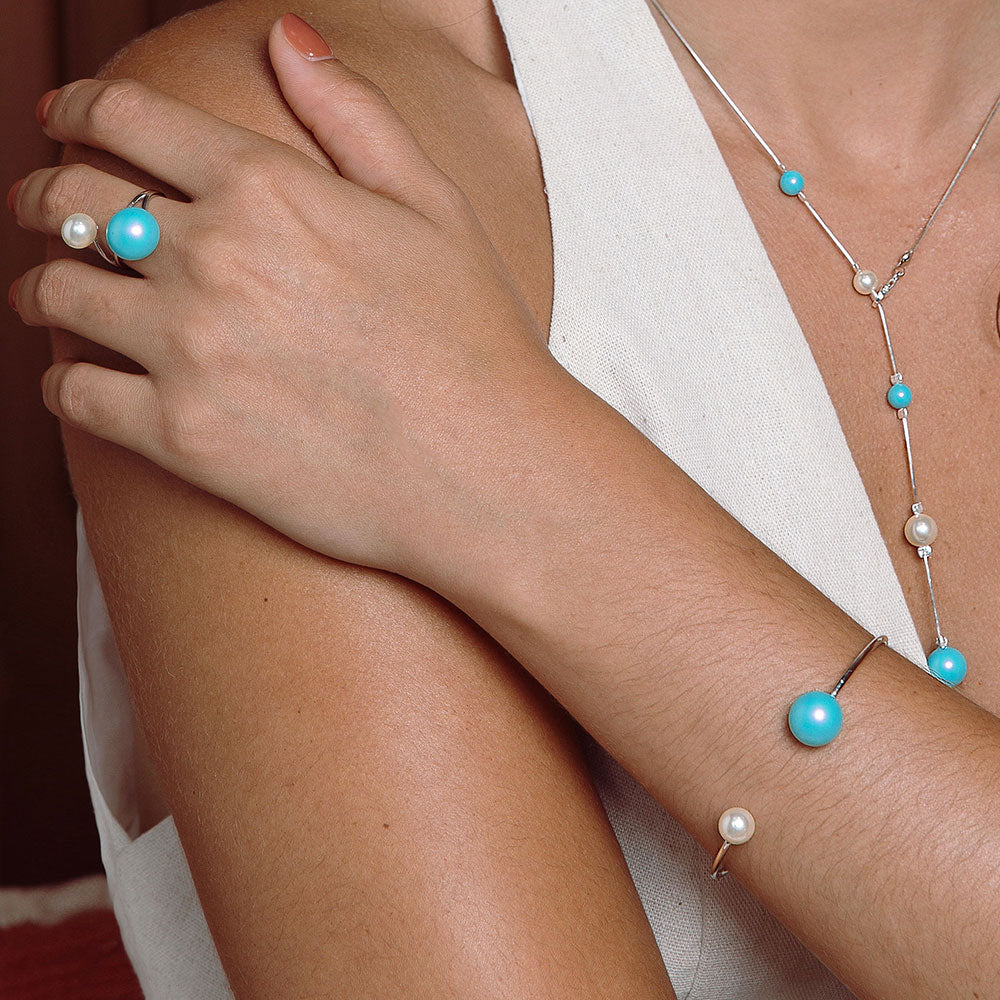 Nerina double pearl cuff bracelet and ring white and blue pearls with silver band left arm over right shoulder