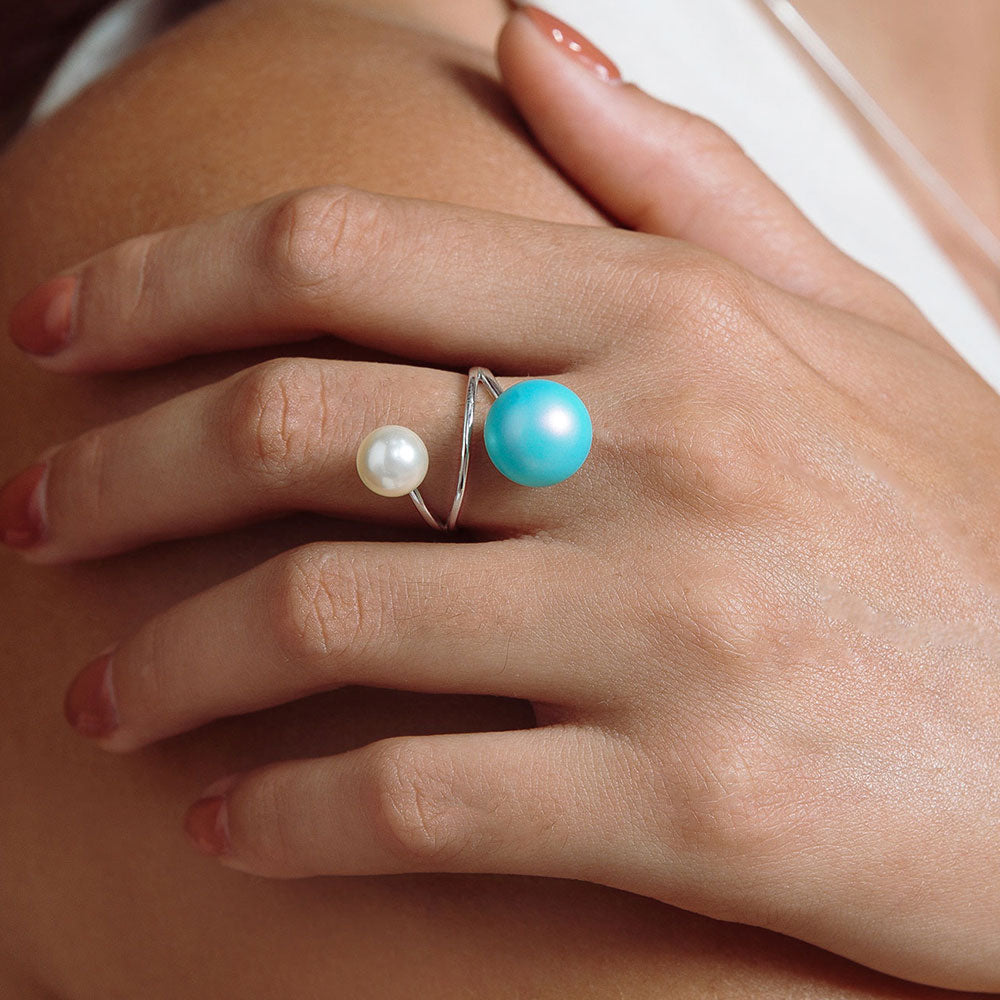 Nerina double pearl wrap ring white and blue pearl with silver band close up left hand over right shoulder