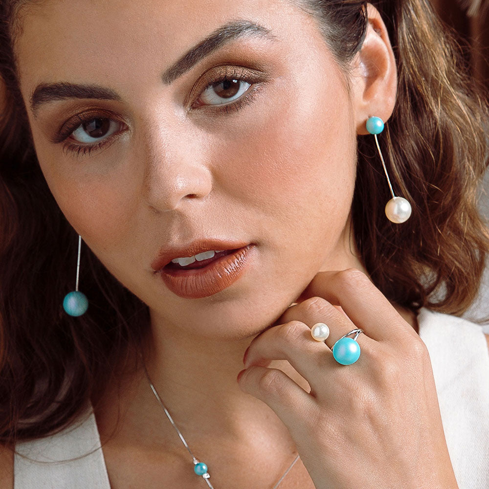 Nerina mixed pearl drop earrings and double pearl wrap ring left hand under chin