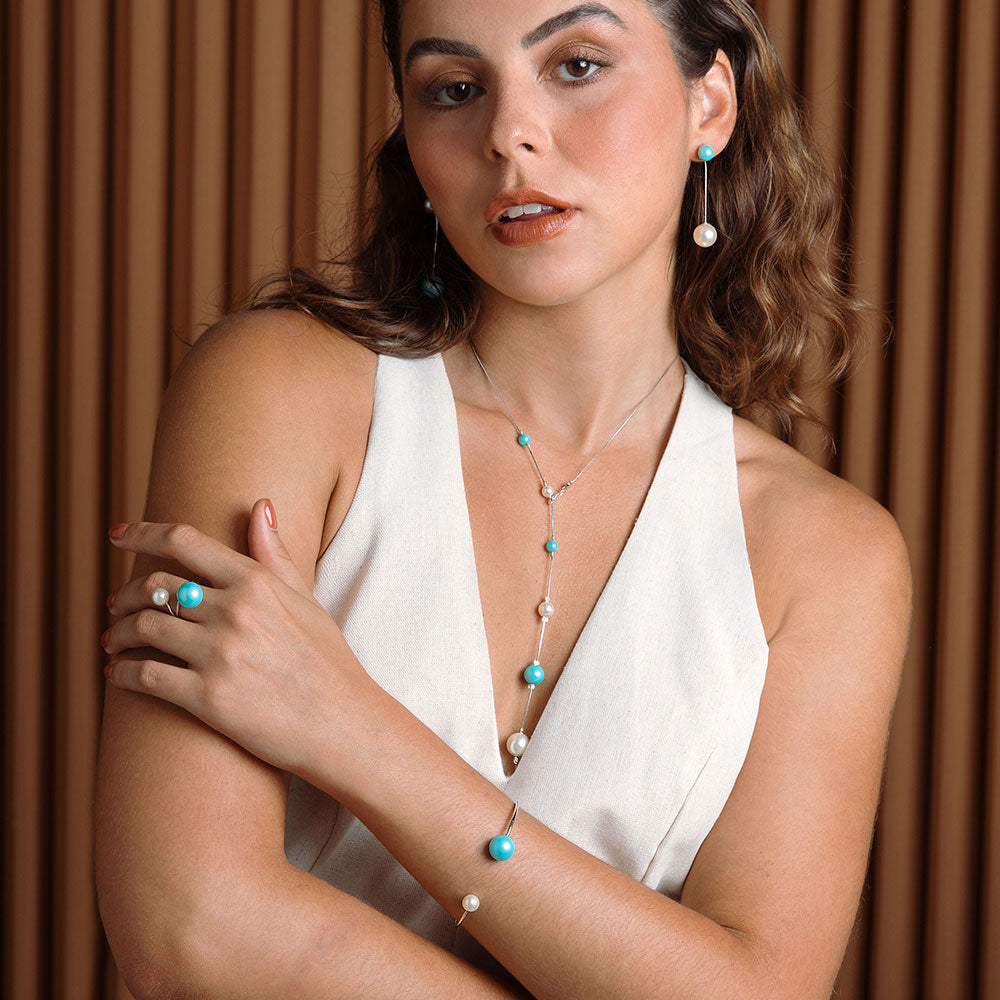 Nerina mixed pearl set including earrings, necklace, ring and bracelet worn with linen dress