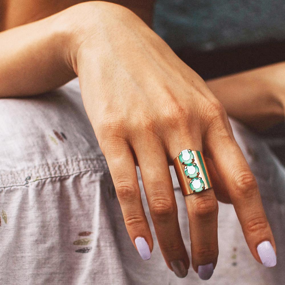 Simone three crystals statement ring rose gold with mint crystals on right hand.