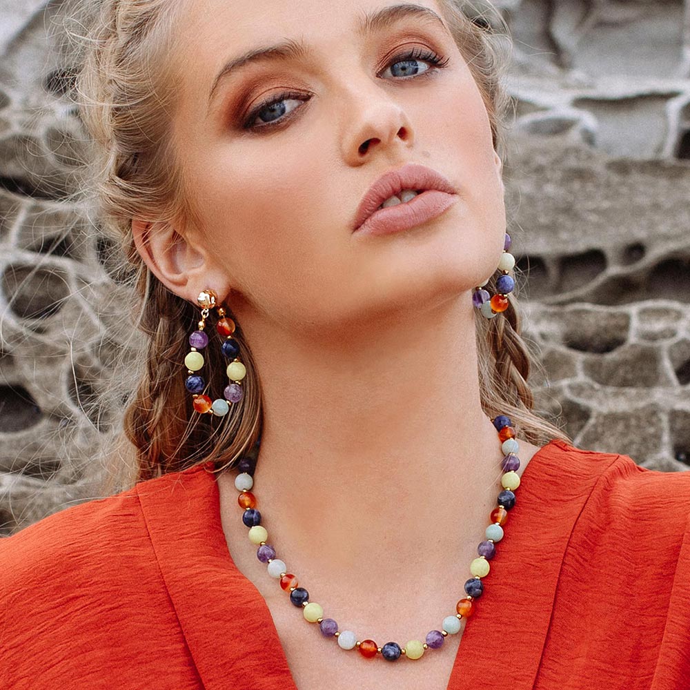 Soleil mutli stone necklace and earrings with beach rocks background