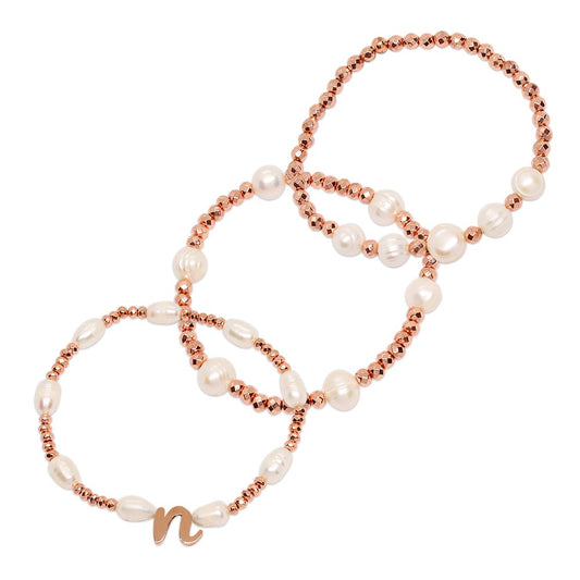 Tarni pearl and rose gold initial bracelet set of three on white background