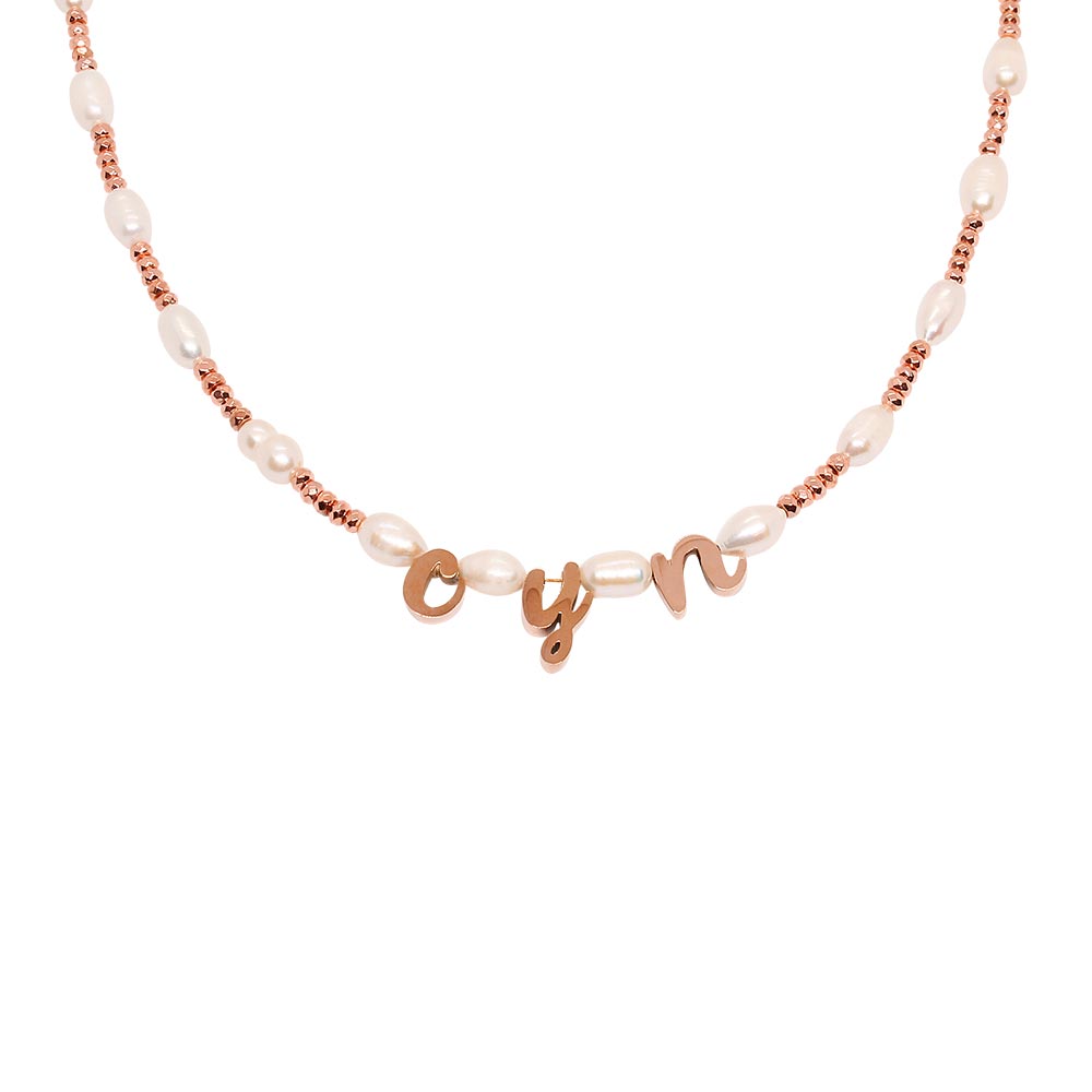 Tarni personalised rose gold and pearl initial necklace with letters c y n close up on white background