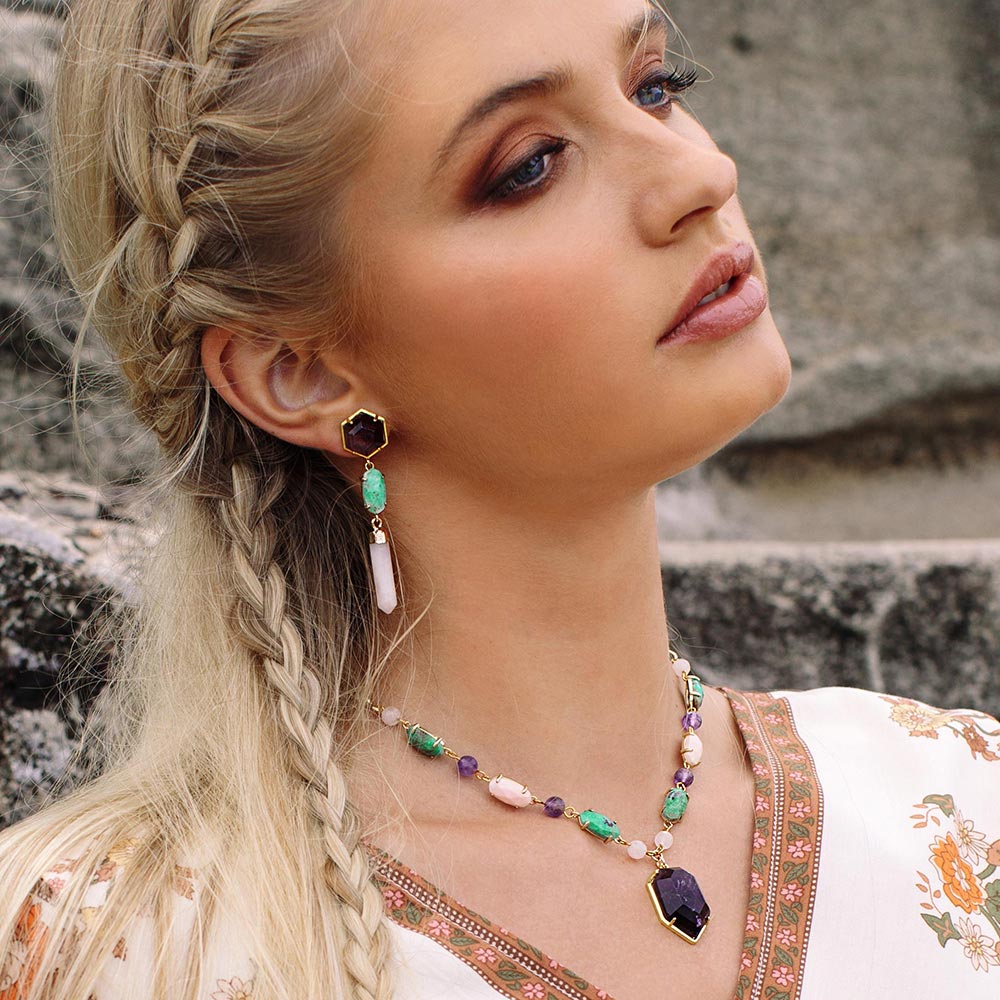 Wylda bohemian multi stone necklace with turquoise, amethyst, rose quartz and gold earrings on right side. 