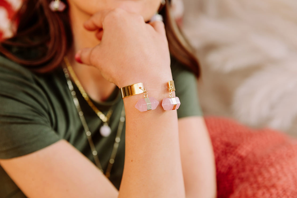 Chakra hexagon stone cuff bracelet on close up of right arm resting on chin