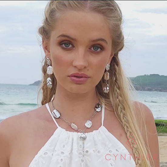 Leora freeform silver and pearl earrings, worn at the beach.