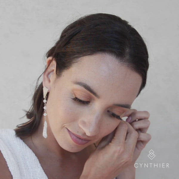 Putting on Ecca earrings in white colour.