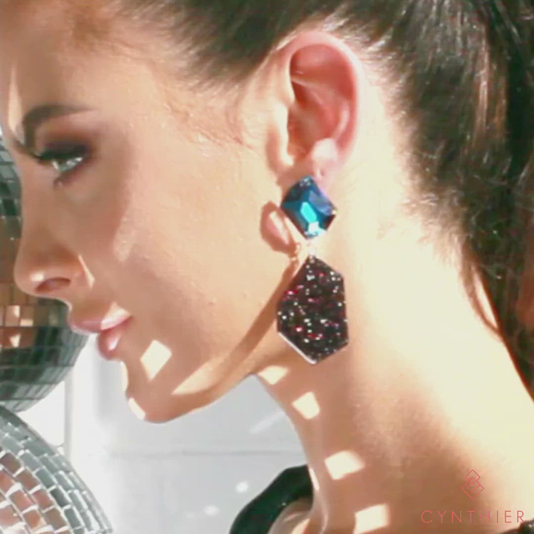 Galaxy earrings on model with shiny disco ball