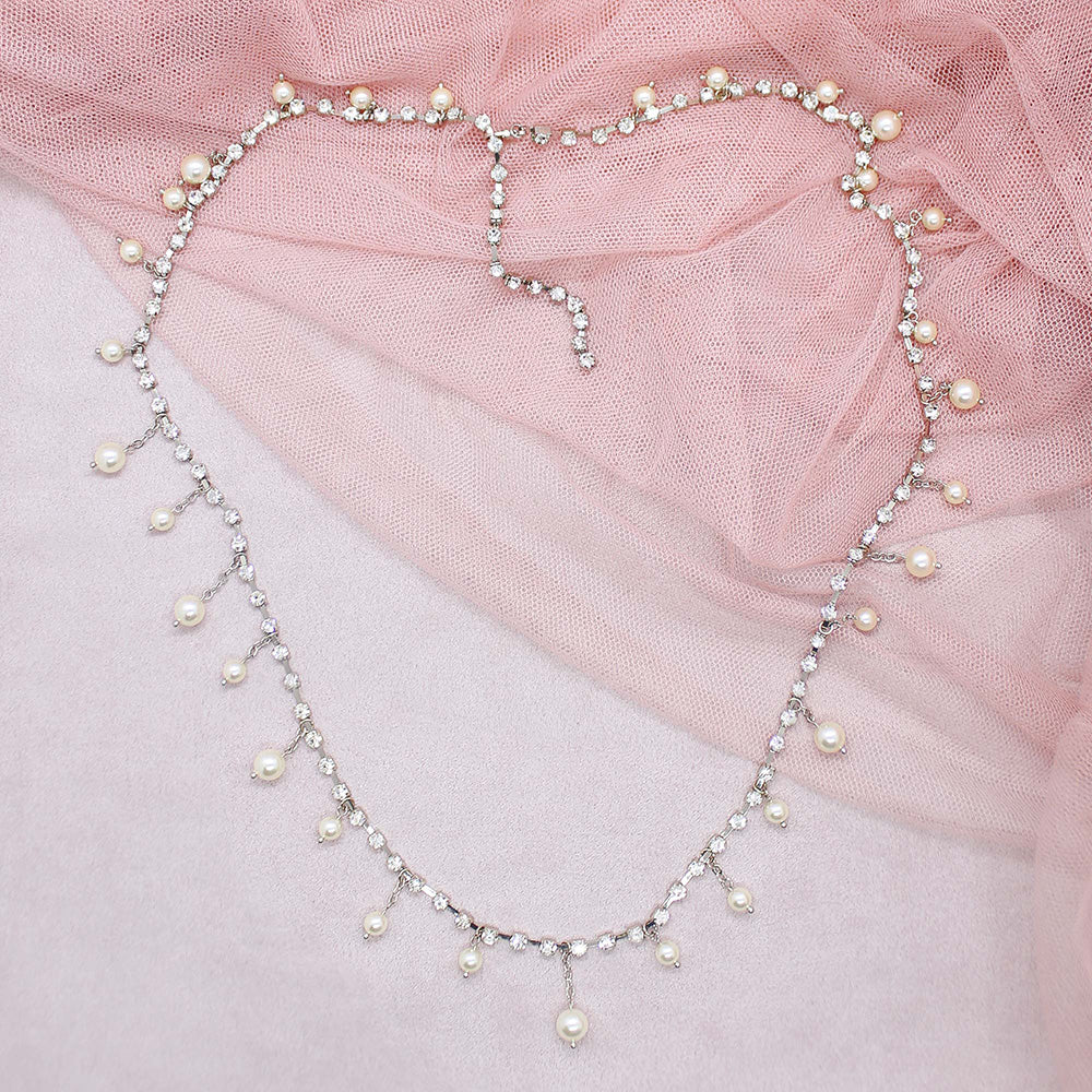 Alexi crystal and pearl necklace on pink fabric background