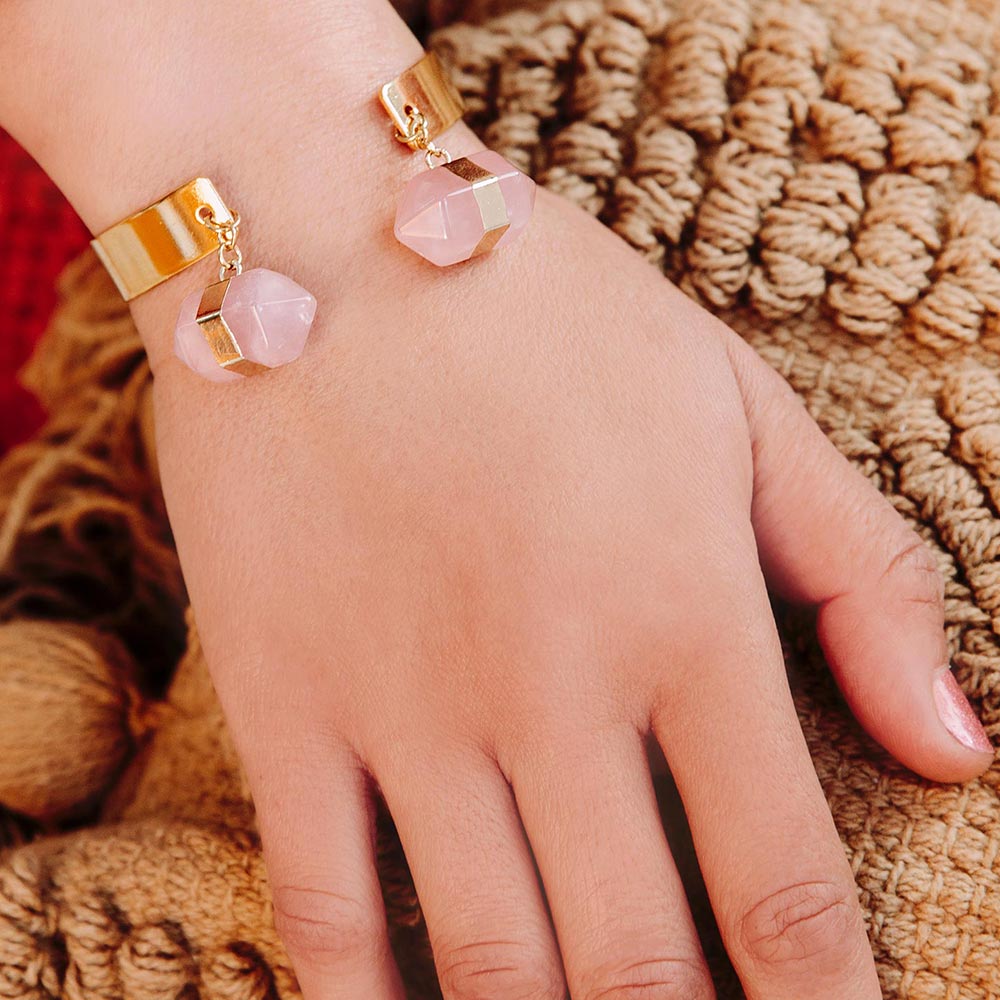 Chakra hexagon stone cuff bracelet rose quartz bracelet worn on right hand over pillow.