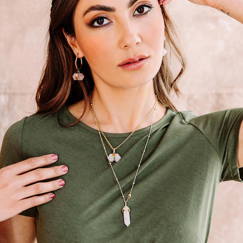 Chakra stone pendant necklaces for layering pink rose quartz and gold with khaki dress left arm up