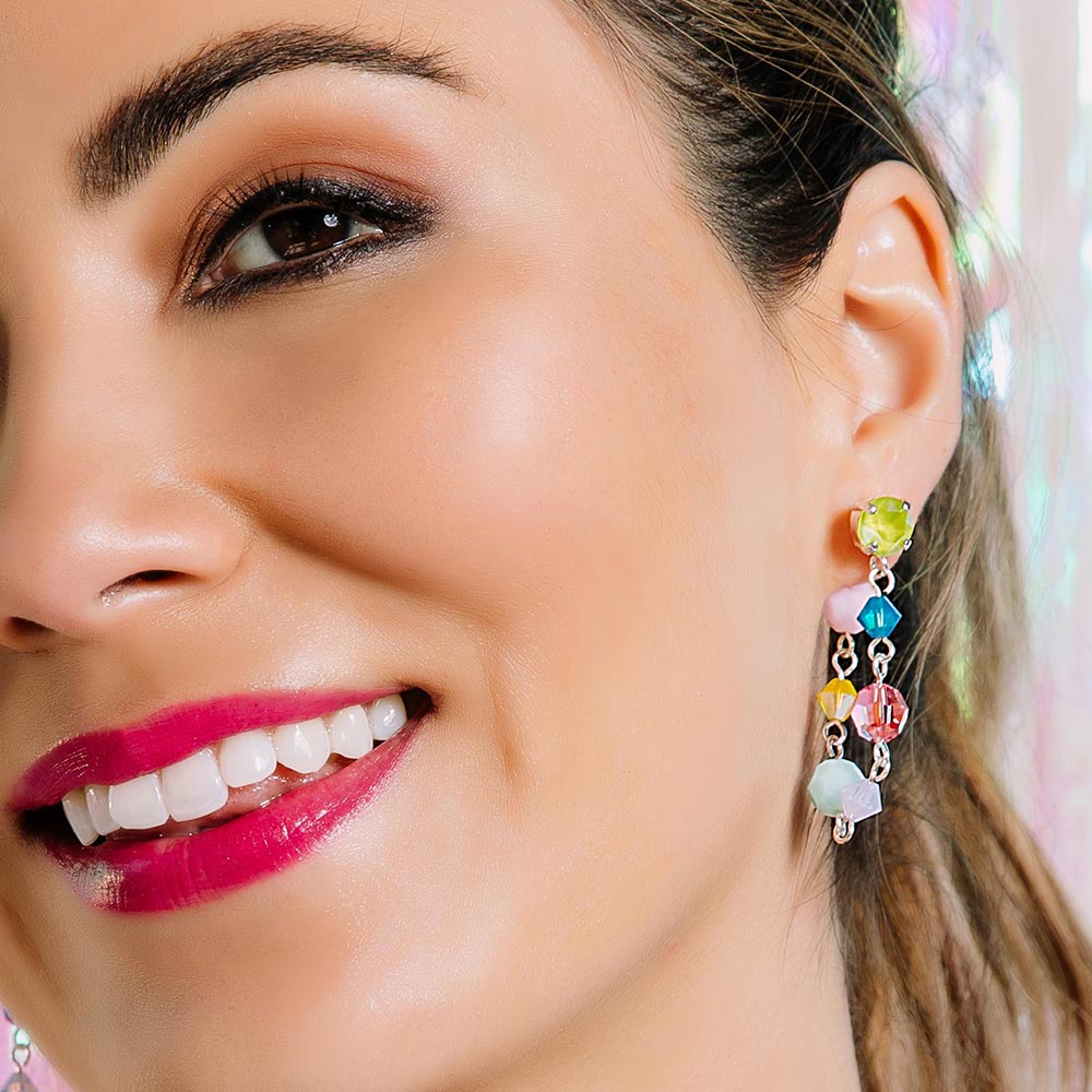 Gelato pastel colour crystal earrings worn loop up close up on left ear smiling