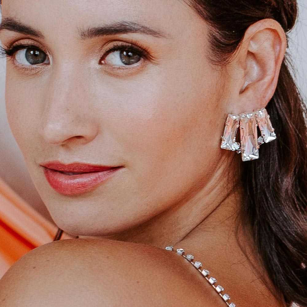 Kara crystal stud earrings on left ear