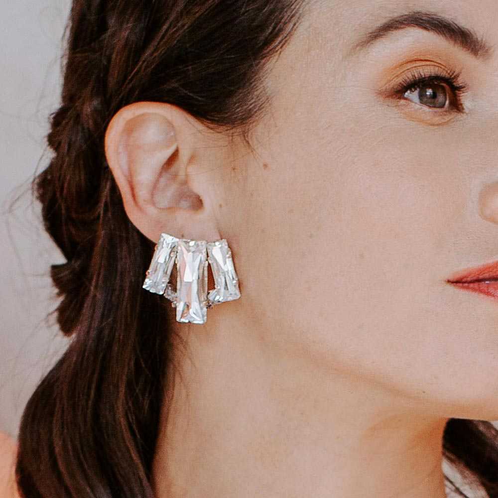 Kara crystal stud earrings on right ear