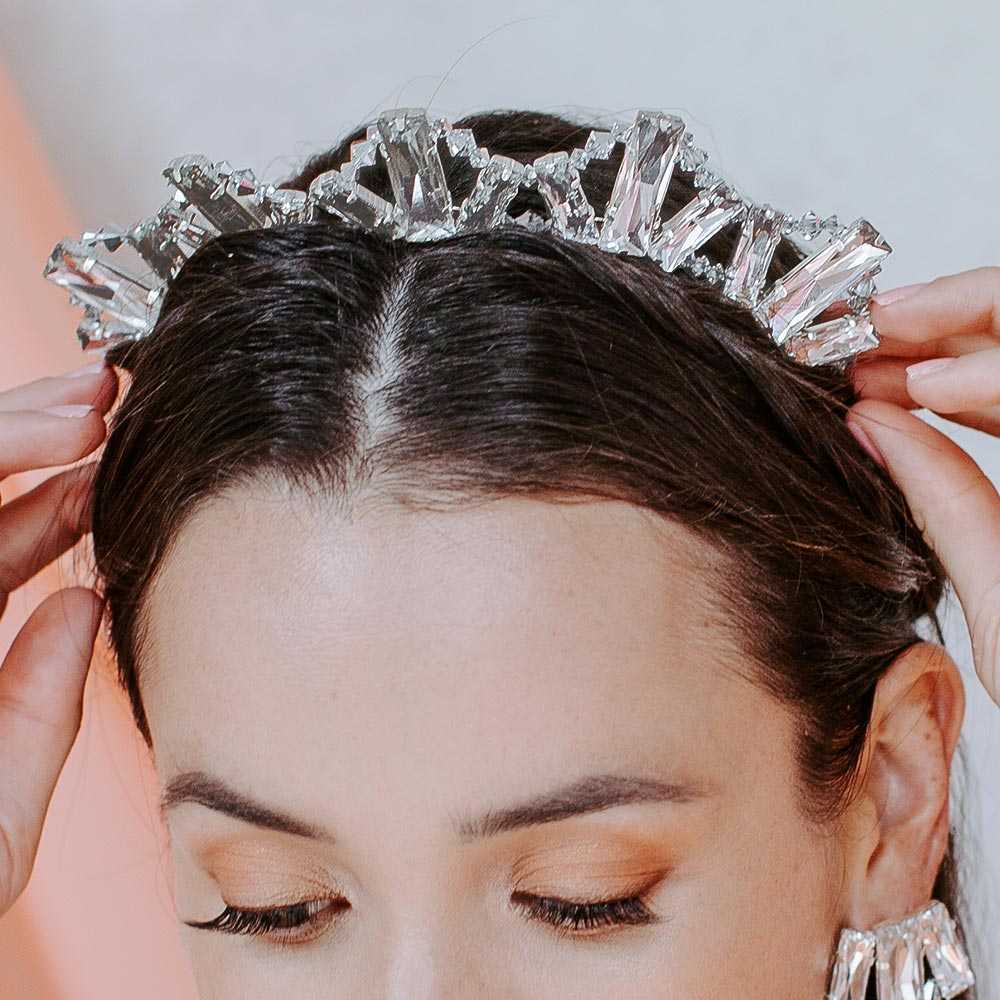 Bride putting on Kara crystal crown