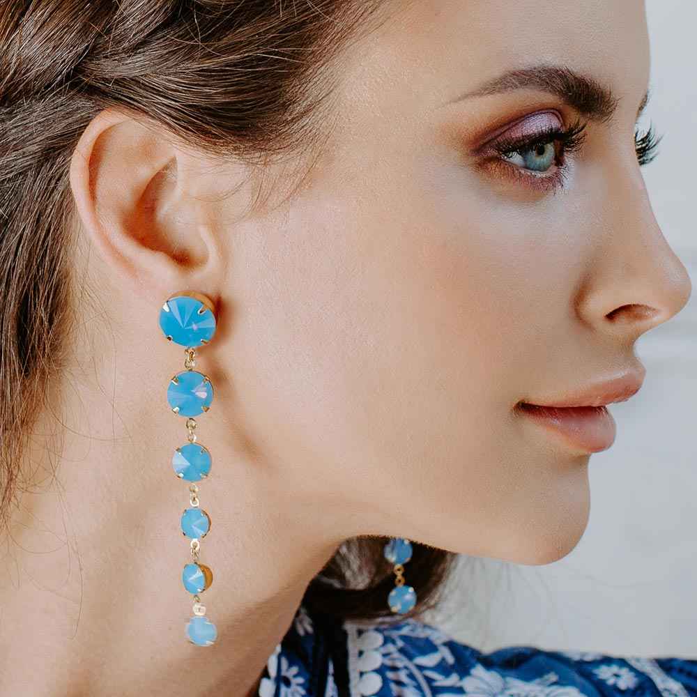 Kelsey Crystal Drop Earrings in Blue on right ear
