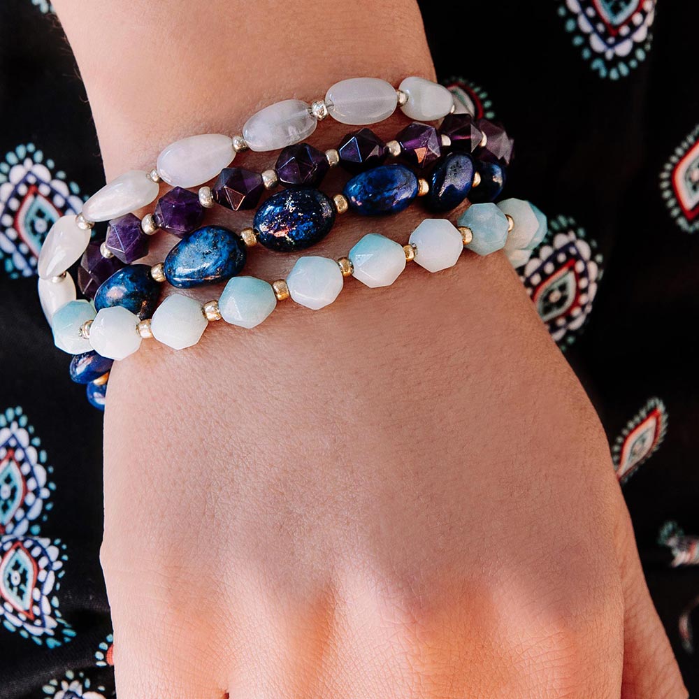 Neomi and Kiana stone bracelets stack worn on right hand with boho print pants.