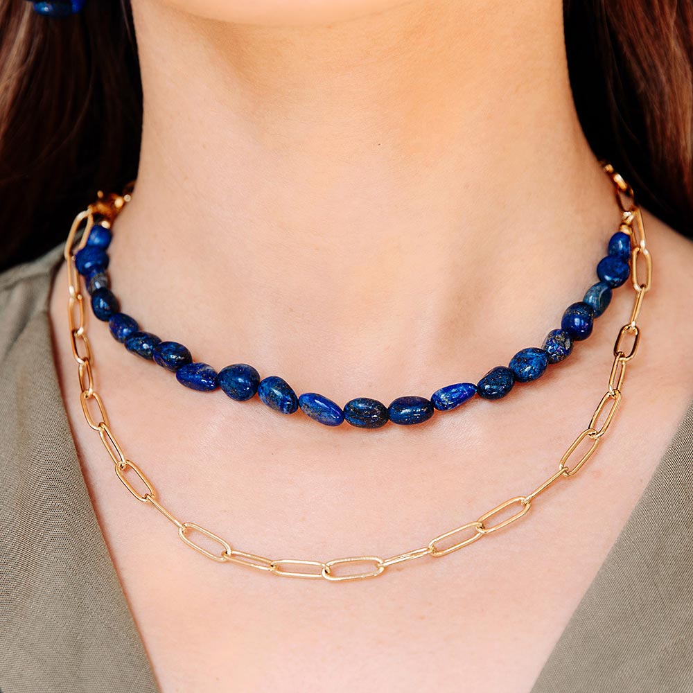Neomi multi way lapis lazuli and chain layered necklace worn short, close up