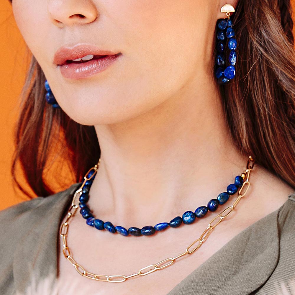 Neomi multi way lapis lazuli and chain layered necklace worn short with Neomi earrings and khaki top.