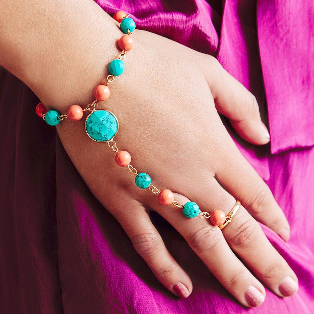 Tinashe turquoise and coral bracelet ring close up of right hand on hip