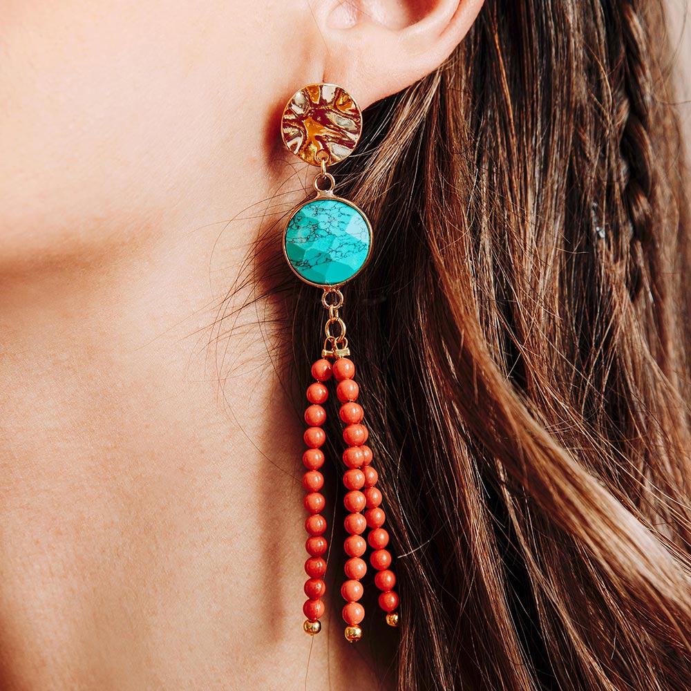 Tinashe turquoise and coral tassel earrings close up left ear