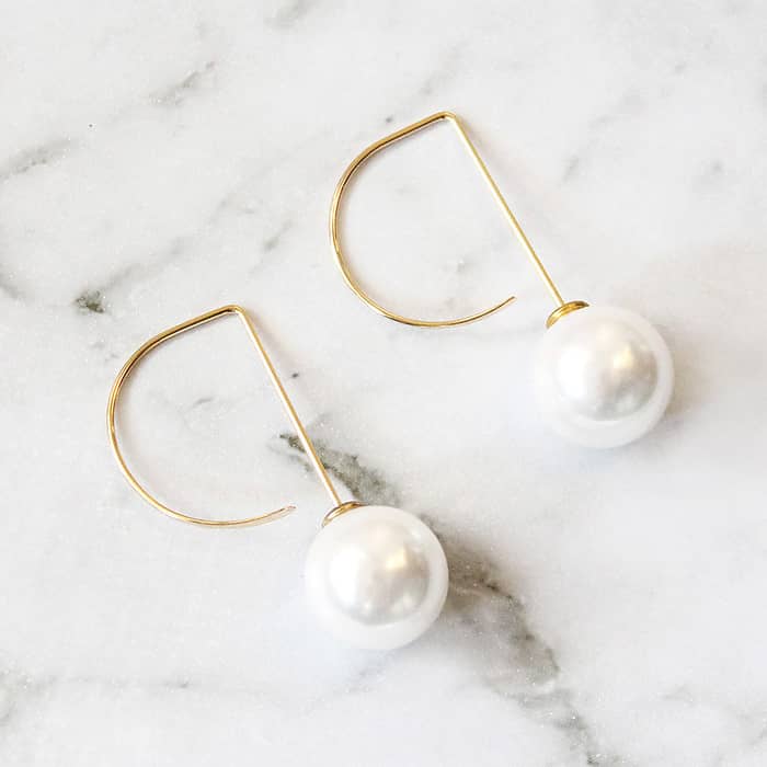 Affordable Pearl Threader Romee Earrings in gold on grey marble