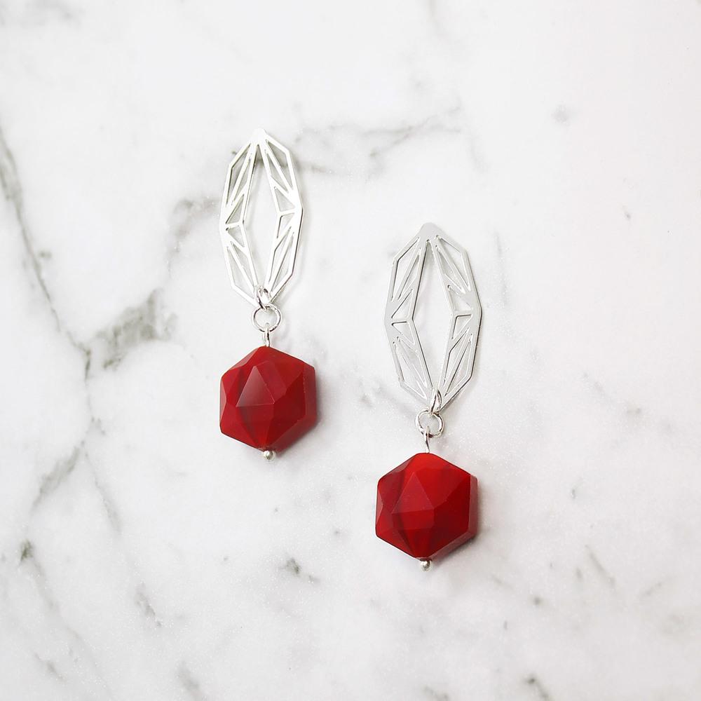 Red Ava hexagonal drop earrings on white