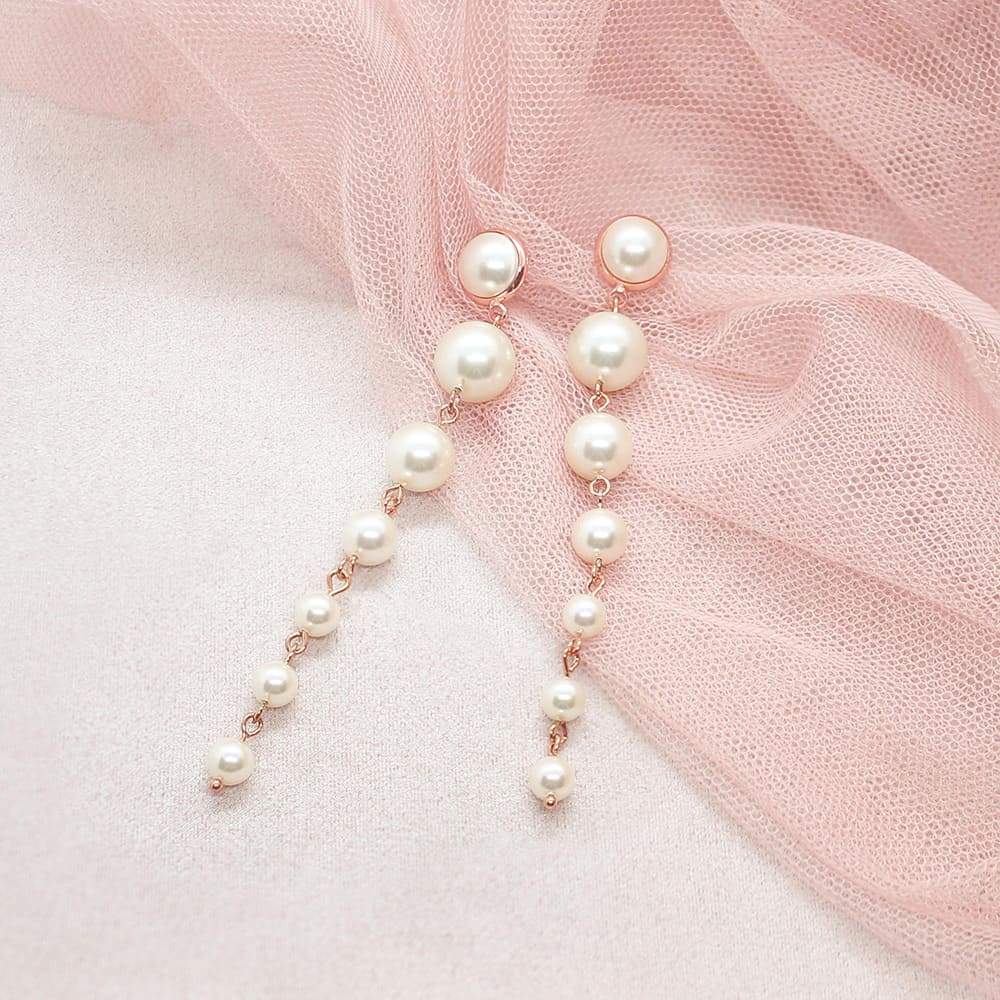 Rose Gold Caiti modern pearl drop earrings on pink