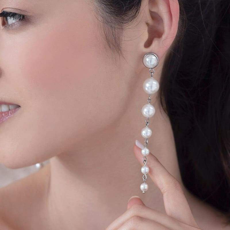 Silver Caiti modern pearl drop earrings from left