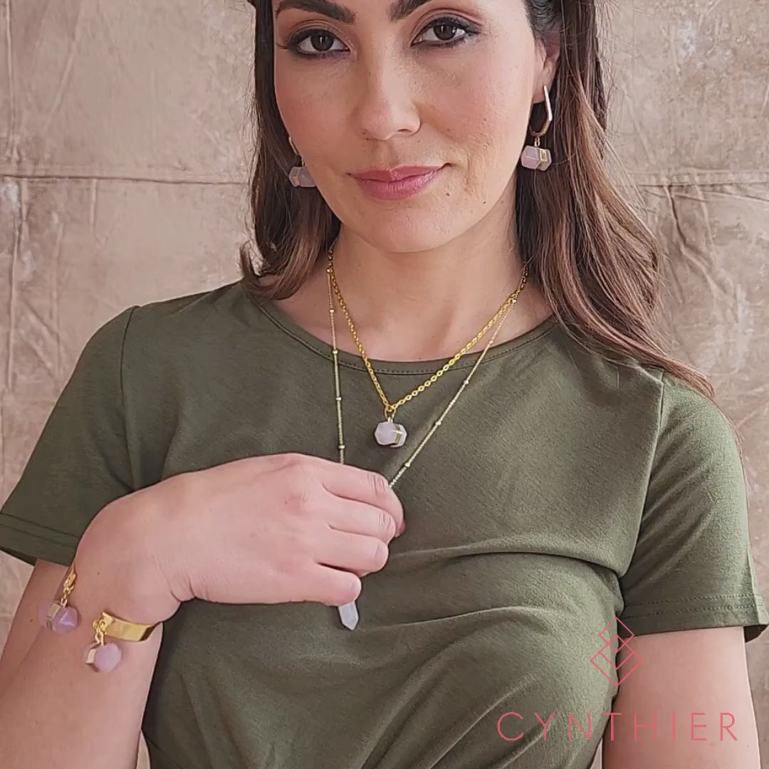 Chakra stone pendant necklaces for layering pink rose quartz and gold worn with khaki dress