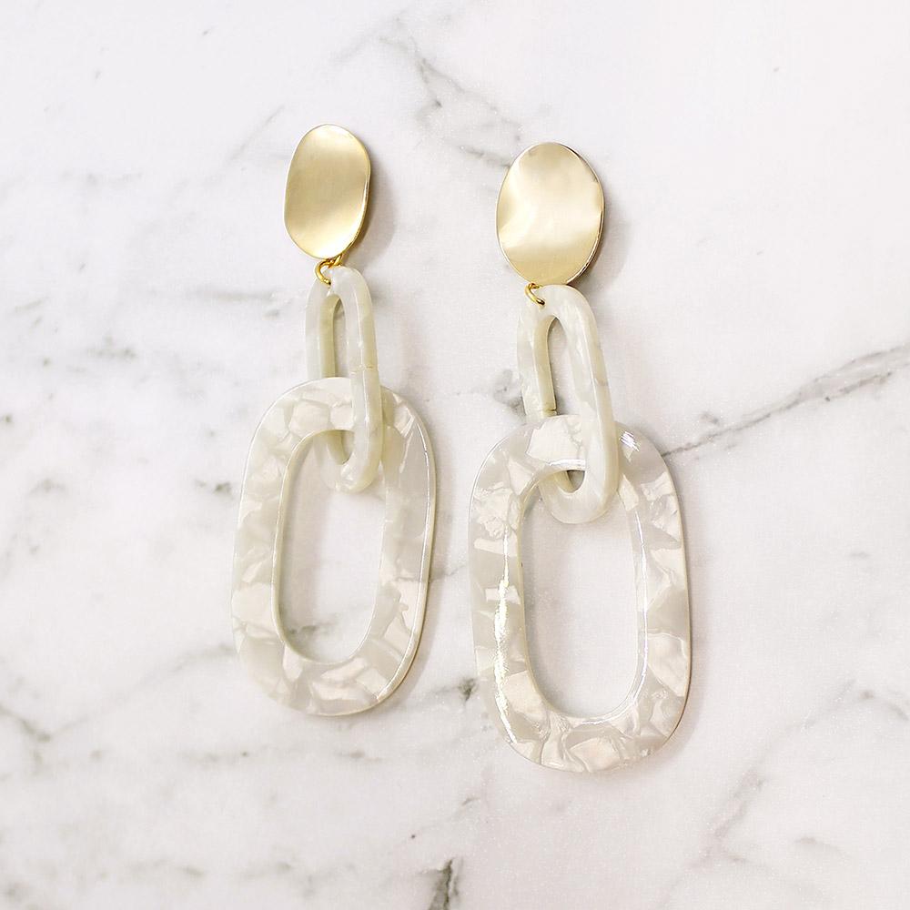 Ivory Joss link earrings on white